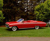 AUT 22 RK0239 02
1962 Chevy Impala Super Sport Convertible Red 3/4 Side View On Grass Hill By Trees