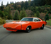 AUT 22 RK0260 01
1969 Dodge Daytona Charger Red 3/4 Front View On Pavement By Trees At Dusk