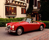 AUT 22 RK0339 05
1962 MG MGA 1600 Mark 2 Convertible Red 3/4 Front View On Pavement By House
