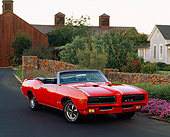AUT 22 RK0478 05
1969 Pontiac GTO The Judge Convertible Red 3/4 Front View On Pavement By Homes Flowers And Trees