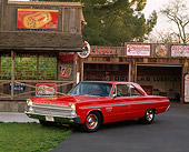 AUT 22 RK0994 03
1965 Plymouth Sports Fury Red 3/4 Front View On Pavement By Garage And Store