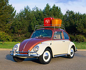 AUT 22 RK1006 01
1965 VW Beetle Steel Sunroof Copper And White 3/4 Front View On Pavement With Basket On Top By Trees