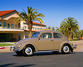 AUT 22 RK1034 02
1963 VW Bug Gray 3/4 Side View On Pavement By Building And Palm Trees Blue Sky
