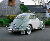 AUT 22 RK1052 01
1960 Volkswagen Beetle Green And Cream 3/4 Rear View On Pavement By Stone Building