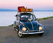 AUT 22 RK1060 13
1960 VW Beetle Black With Roof Rack 3/4 Front View On Pavement By Water Filtered
