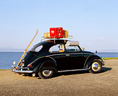 AUT 22 RK1063 04
1960 Volkswagen Beetle Black With Roof Rack 3/4 Rear View On Pavement By Water Blue Sky
