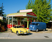 AUT 22 RK1104 10
1969 Volkswagen Karmann Ghia Yellow And 1955 Volkswagen Barn Door Panel Bus Blue By Old Gas Station
