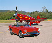 AUT 22 RK1118 01
1967 Sunbeam Tiger MKII Convertible Red 3/4 Front View YAK 9U Airplane On Pavement Blue Sky