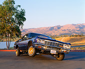 AUT 22 RK1138 03
1966 Chevy Impala Lowrider Purple Low 3/4 Front View On Pavement By Water Mountains