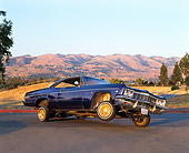 AUT 22 RK1139 02
1966 Chevy Impala Lowrider Purple 3/4 Side View On Pavement Mountains Blue Sky