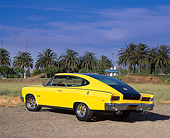 AUT 22 RK1163 02
1965 AMC Rambler Marlin Yellow 3/4 Rear View On Pavement Palm Trees