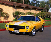 AUT 22 RK1175 01
1968 AMC AMX Yellow With White Stripe 3/4 Front View On Pavement By Building