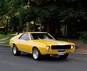 AUT 22 RK1177 03
1968 AMC AMX Yellow With White Stripe 3/4 Front View On Pavement By Trees