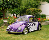 AUT 22 RK1199 01
1965 VW Bug Purple And White With Flames 3/4 Front View On Grass By Flowers And Trees