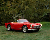 AUT 22 RK1215 02
1961 Maserati Vignale Convertible Red 3/4 Side View On Grass By Trees