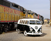 AUT 22 RK1264 10
1964 Volkswagen Bus Black And White Front 3/4 View On Dirt By Train