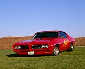 AUT 22 RK1269 01
1968 Pontiac GTO Red Custom Design 3/4 Front View On Grass Hills Blue Sky