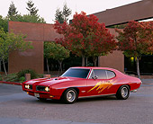 AUT 22 RK1274 02
1968 Pontiac GTO Red Custom Design 3/4 Side View On Pavement By Building And Fall Trees