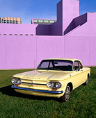 AUT 22 RK1349 05
1964 Chevrolet Corvair Monza Sport Yellow 3/4 Front View On Grass By Purple Building