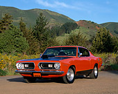 AUT 22 RK1451 01
1967 Plymouth Barracuda Hemi Orange And Black 3/4 Front View On Dirt By Trees And Bushes