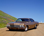 AUT 22 RK1470 02
1965 Chevrolet Impala SS Prostreet Gold 3/4 Front View On Dirt By Hill