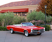 AUT 22 RK1564 04
1967 Pontiac GTO Convertible Red 3/4 Side View By Trees Bushes And Building