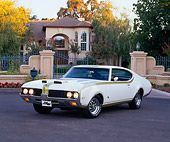 AUT 22 RK1591 05
1969 Hurst Oldsmobile Special Edition White Green Stripe 3/4 Front View Pavement By Gated House