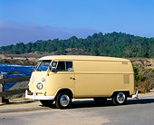 AUT 22 RK1629 01
1965 VW Panel Van Yellow 3/4 Front View On Pavement Water And Trees Background