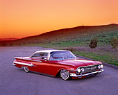 AUT 22 RK1654 01
1960 Chevrolet Impala Red And White Lowrider 3/4 Front View On Gravel By Grass Hill Filtered