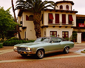 AUT 22 RK1693 02
1969 Chevy Malibu Green Black Top 3/4 Front View By Spanish Building And Palm Trees