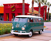 AUT 22 RK1791 02
1967 Volkswagen Bus Teal And White With A Surfboard 3/4 Front View By Palm Trees And Building