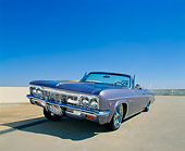 AUT 22 RK1808 02
1966 Chevy Impala Convertible Violet 3/4 Front View Raised On Pavement Blue Sky