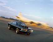 AUT 22 RK1842 01
1968 Plymouth Hurst Hemi Barracuda Black 3/4 Front View On Pavement Airplane Landing Background