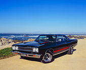 AUT 22 RK1911 03
1968 Plymouth GTX Black With Red Stripe 3/4 Front View On Sand By Ocean