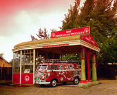 AUT 22 RK1920 01
1961 VW Bus Ragtop Rusty With Stickers 3/4 Side View By Old Gas Station