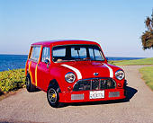 AUT 22 RK2001 02
1962 Austin Mini Traveller Woody Red White Stripes 3/4 Front View On Pavement By Water