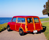 AUT 22 RK2002 02
1962 Austin Mini Traveller Woody Red White Stripes 3/4 Rear View On Pavement By Water