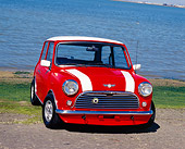 AUT 22 RK2021 01
1968 Austin Mini Cooper MKI Orange White Stripes 3/4 Front View On Pavement By Water