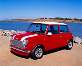 AUT 22 RK2042 01
1969 Austin Mini Cooper MKIII Red White Stripes 3/4 Side View On Sand By Water