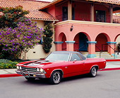 AUT 22 RK2077 04
1969 Chevy El Camino Red Black Stripes 3/4 Side View On Pavement By Building