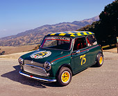 AUT 22 RK2104 01
1964 Morris Mini Cooper Green And Yellow 3/4 Front View On Pavement Mountains Background