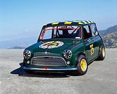AUT 22 RK2107 04
1964 Morris Mini Cooper Green And Yellow 3/4 Front View On Pavement Hill Blue Sky