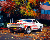 AUT 22 RK2135 01
1967 Chevy Chevelle White With Flames Low 3/4 Front View By Fall Trees And Building