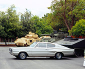 AUT 22 RK2171 05
1966 Dodge Charger Silver Gray 3/4 Front View On Pavement By Tanks