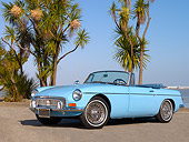 AUT 22 RK2327 01
1965 MG MGB Convertible Iris Blue Low 3/4 Side View On Pavement