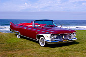 AUT 22 RK2348 01
1960 Plymouth Fury Convertible Plum Red 3/4 Front View On Grass By Water