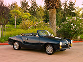 AUT 22 RK2384 01
1969 VW Karmann Ghia Convertible Green 3/4 Side View On Pavement By Trees