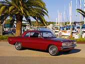 AUT 22 RK2523 01
1962 Pontiac Tempest LeMans Burgundy 3/4 Side View On Pavement By Harbor