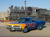 AUT 22 RK2732 01
1966 Pontiac LeMans Blue Orange Flames 3/4 Front View On Pavement By Train