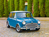 AUT 23 BK0046 01
1970 Mini Cooper S Blue 3/4 Front View On Pavement By Shrubs